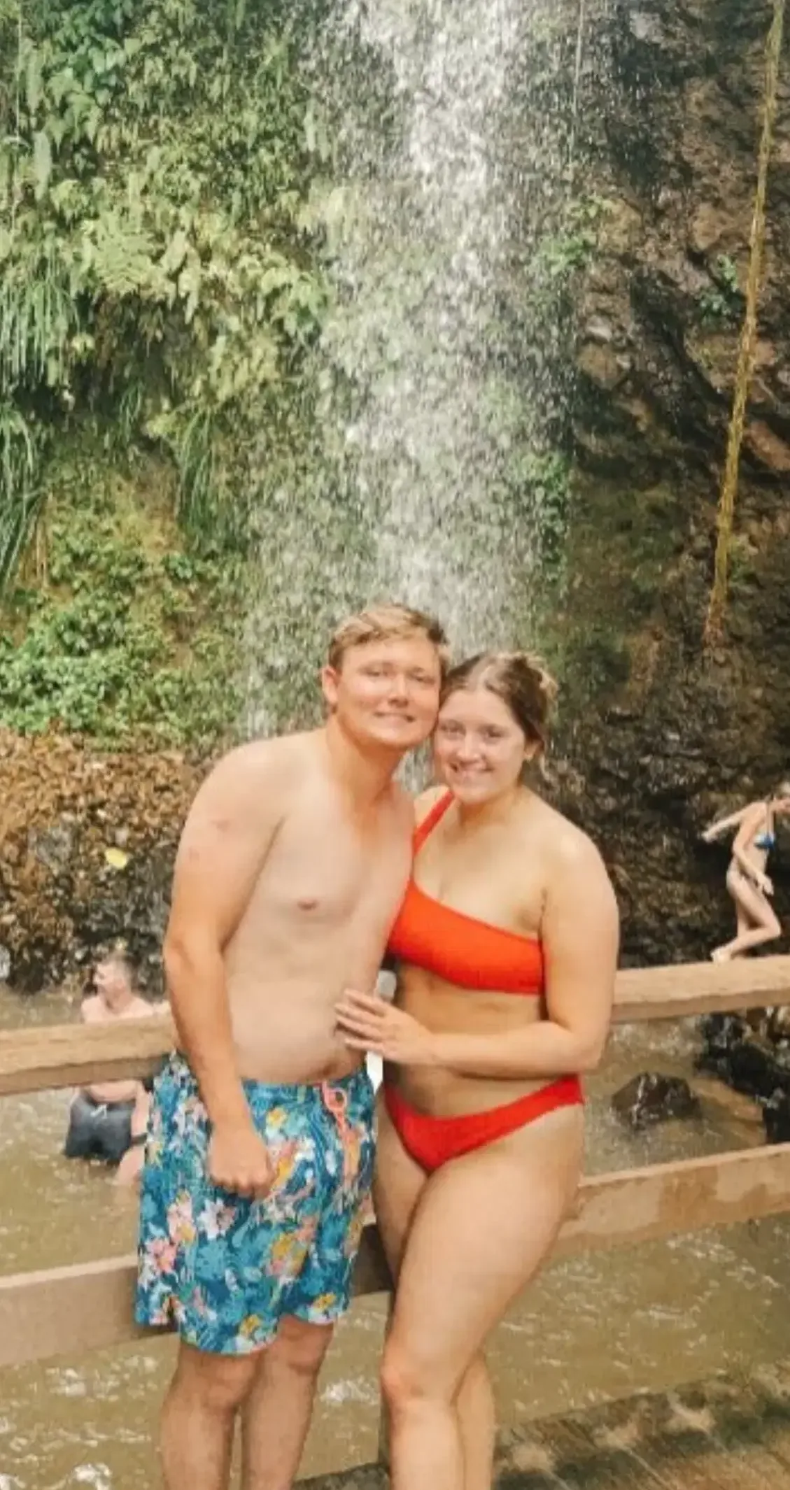 A couple enjoying a waterfall excursion during their honeymoon in St. Lucia